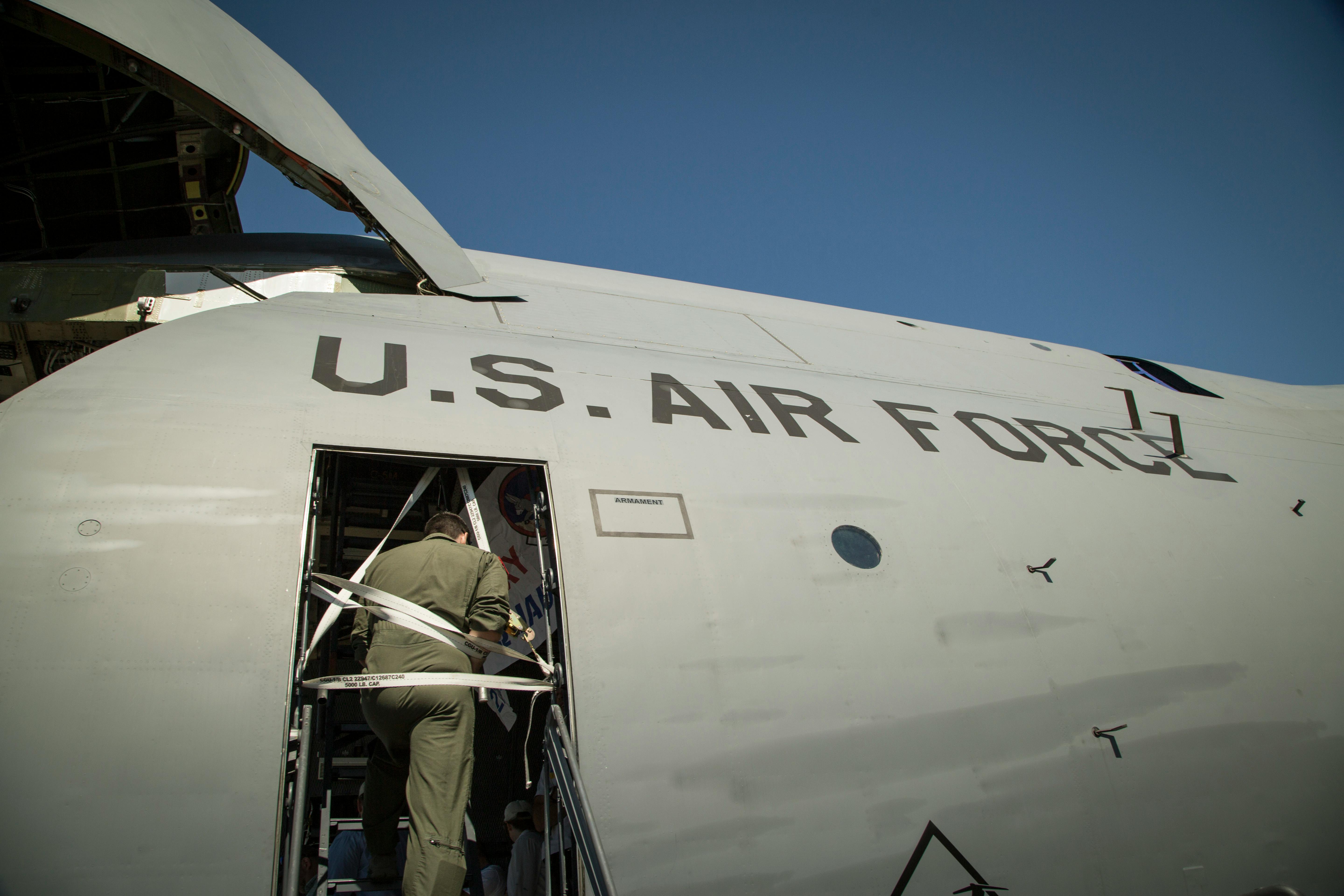 Military cargo aircraft loading operations on a flightline