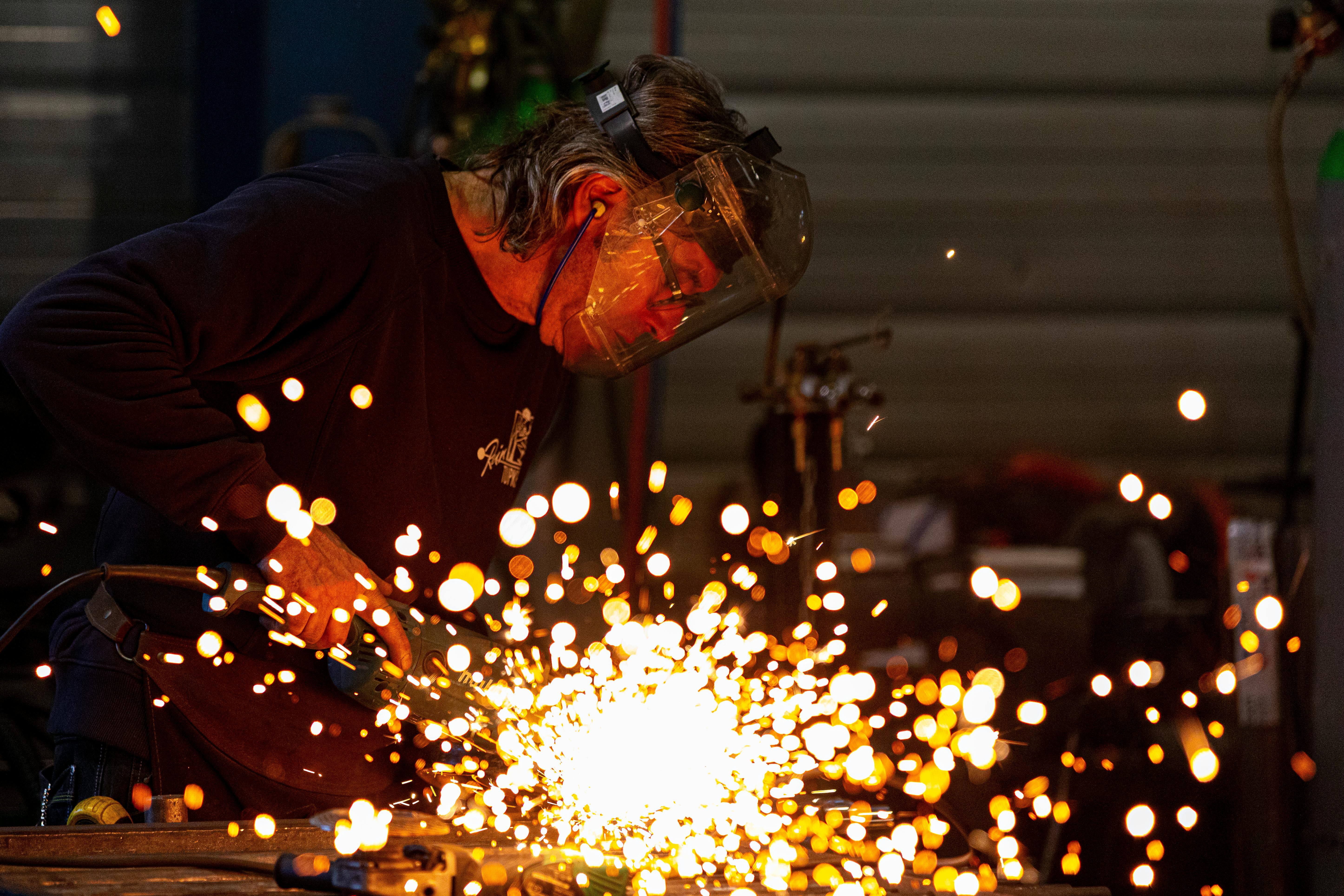 Precision welding sparks in a dark industrial setting
